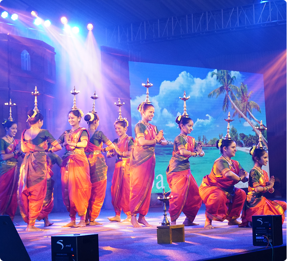 Traditional dance troupe performing in colorful costumes on stage