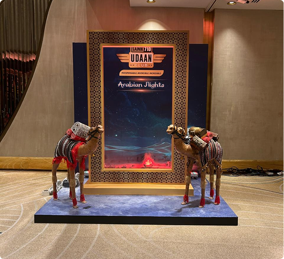 Arabian Nights themed stage installation with decorative camel props