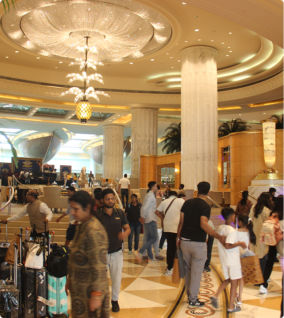 Grand chandelier-lit hotel lobby with guests gathering